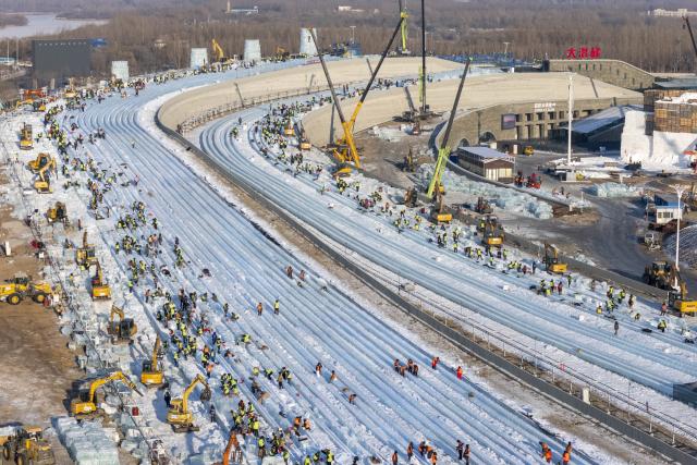 (251205) -- HARBIN, Dec. 5, 2025 (Xinhua) -- An aerial drone photo taken on Dec. 5, 2025 shows workers operating at the construction site of Ice and Snow World in Harbin, northeast China's Heilongjiang Province. The 27th edition of Ice and Snow World in Harbin has recently kicked off its construction work, which involves more than 10,000 workers and about 1,000 machines. The park area is expected to be extended to 1.2 million square meters, the largest of all editions in history. (Xinhua/Zhang Tao)