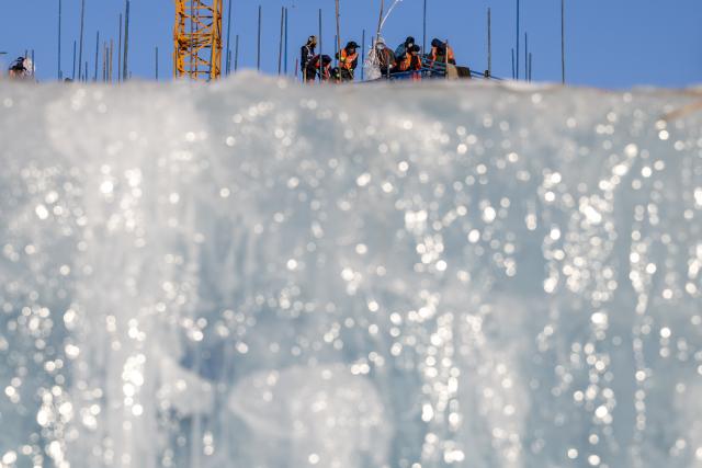 (251205) -- HARBIN, Dec. 5, 2025 (Xinhua) -- Workers are seen at the construction site of Ice and Snow World in Harbin, northeast China's Heilongjiang Province, Dec. 5, 2025. The 27th edition of Ice and Snow World in Harbin has recently kicked off its construction work, which involves more than 10,000 workers and about 1,000 machines. The park area is expected to be extended to 1.2 million square meters, the largest of all editions in history. (Xinhua/Zhang Tao)