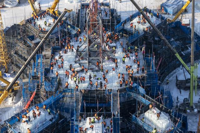 (251205) -- HARBIN, Dec. 5, 2025 (Xinhua) -- An aerial drone photo taken on Dec. 5, 2025 shows workers operating at the construction site of Ice and Snow World in Harbin, northeast China's Heilongjiang Province. The 27th edition of Ice and Snow World in Harbin has recently kicked off its construction work, which involves more than 10,000 workers and about 1,000 machines. The park area is expected to be extended to 1.2 million square meters, the largest of all editions in history. (Xinhua/Zhang Tao)