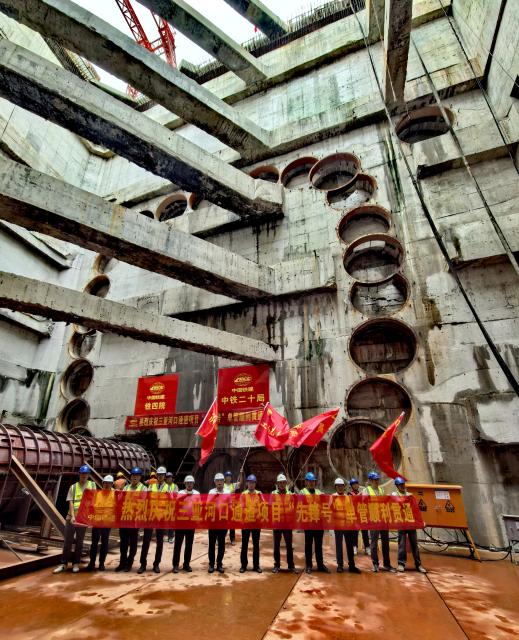 (251205) -- SANYA, Dec. 5, 2025 (Xinhua) -- Staff members celebrate tunnel drill-through of the Sanya River estuary passage project in Sanya, south China's Hainan Province, Dec. 5, 2025. The Sanya River estuary passage project undertaken by China Railway 20th Bureau Group was successfully drilled through on Friday. This 3.118-kilometer underwater tunnel, the first of its kind in Sanya, is expected to further optimize the urban spatial layout of the city, and facilitate the development of the Hainan Free Trade Port. (Xinhua/Zhao Yingquan)
