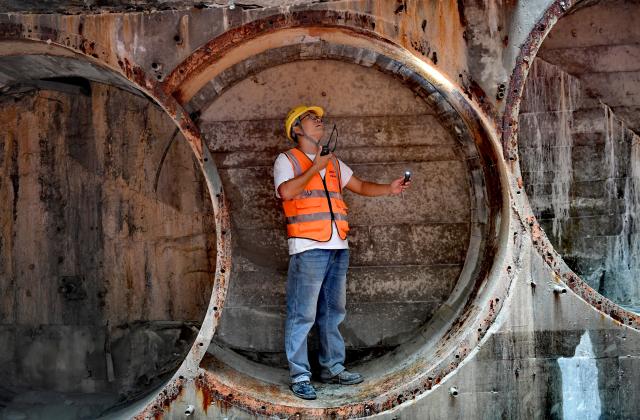 (251205) -- SANYA, Dec. 5, 2025 (Xinhua) -- A staff member works at the construction site of the Sanya River estuary passage project in Sanya, south China's Hainan Province, Dec. 5, 2025. The Sanya River estuary passage project undertaken by China Railway 20th Bureau Group was successfully drilled through on Friday. This 3.118-kilometer underwater tunnel, the first of its kind in Sanya, is expected to further optimize the urban spatial layout of the city, and facilitate the development of the Hainan Free Trade Port. (Xinhua/Zhao Yingquan)
