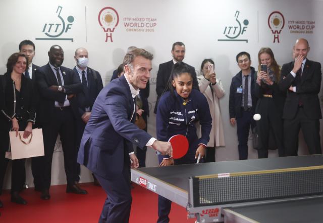 (251205) -- CHENGDU, Dec. 5, 2025 (Xinhua) -- French President Emmanuel Macron plays table tennis during a meeting with Chinese and French table tennis players participating the ITTF Mixed Team World Cup 2025 in Chengdu, southwest China's Sichuan Province, Dec. 5, 2025. (Photo by Liu Yuchen/Xinhua)