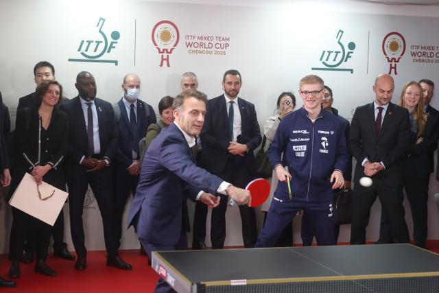 (251205) -- CHENGDU, Dec. 5, 2025 (Xinhua) -- French President Emmanuel Macron plays table tennis during a meeting with Chinese and French table tennis players participating the ITTF Mixed Team World Cup 2025 in Chengdu, southwest China's Sichuan Province, Dec. 5, 2025. (Photo by Liu Yuchen/Xinhua)