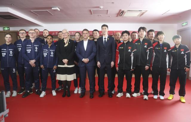 (251205) -- CHENGDU, Dec. 5, 2025 (Xinhua) -- French President Emmanuel Macron meets with Chinese and French table tennis players participating the ITTF Mixed Team World Cup 2025 in Chengdu, southwest China's Sichuan Province, Dec. 5, 2025. (Photo by Liu Yuchen/Xinhua)