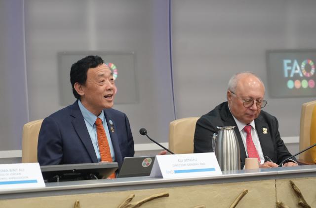 (251205) -- ROME, Dec. 5, 2025 (Xinhua) -- FAO Director-General Qu Dongyu (L) delivers a speech at the World Soil Day celebration held at the FAO headquarters in Rome, Italy, Dec. 5, 2025. Zhang Ganlin, a researcher at the Institute of Soil Science under the Chinese Academy of Sciences, received the 2025 Glinka World Soil Prize on Friday at the World Soil Day celebration held at the headquarters of the Food and Agriculture Organization of the United Nations (FAO) in Rome. (Xinhua/Ren Yaoting)
