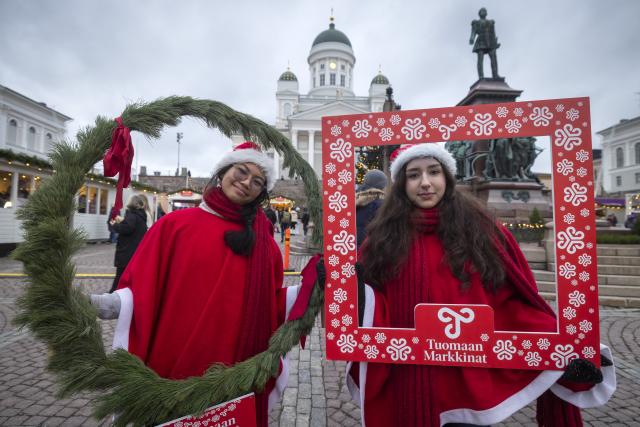 (251205) -- HELSINKI, Dec. 5, 2025 (Xinhua) -- Two women wearing Christmas-themed outfits pose for photo at Helsinki Christmas Market in Helsinki, Finland, on Dec. 5, 2025. Held in Senate Square in the heart of the city, the Helsinki Christmas Market is a historic outdoor Christmas fair that attracts large numbers of visitors every year. This year's Market is open from Nov. 28 to Dec. 22. (Photo by Matti Matikainen/Xinhua)
