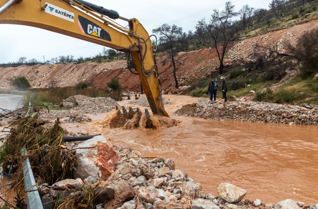 (251205) -- MANDRA, Dec. 5, 2025 (Xinhua) -- A rescuer operates heavy machinery to clear a landslide-blocked road in Mandra, western Attica, about 20 kilometers west of central Athens, Greece, Dec. 5, 2025. A powerful storm, named Byron by local meteorologists, continued to batter Greece for a second consecutive day on Friday, triggering widespread flooding. (Photo by Marios Lolos/Xinhua)