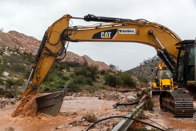 (251205) -- MANDRA, Dec. 5, 2025 (Xinhua) -- People operate heavy machinery to clear a landslide-blocked road in Mandra, in western Attica, about 20 kilometers west of central Athens, Greece, Dec. 5, 2025. A powerful storm, named Byron by local meteorologists, continued to batter Greece for a second consecutive day on Friday, triggering widespread flooding. (Photo by Marios Lolos/Xinhua)