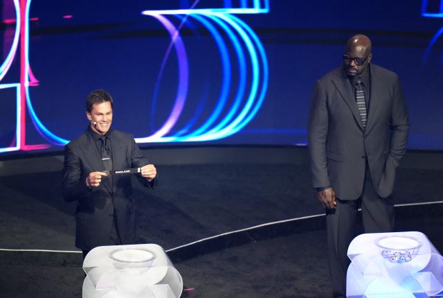 (251206) -- WASHINGTON D.C., Dec. 6, 2025 (Xinhua) -- Draw assistant Tom Brady holds the ticket of England during the FIFA World Cup 2026 Final Draw at the Kennedy Center in Washington D.C., the United States, Dec. 5, 2025. (Xinhua/Wu Xiaoling)