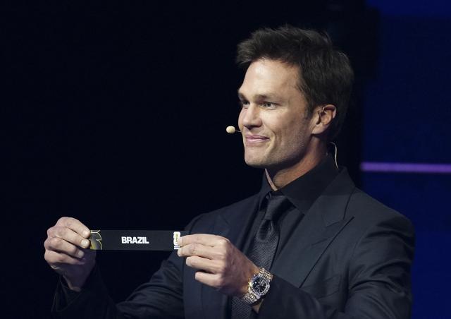 (251206) -- WASHINGTON D.C., Dec. 6, 2025 (Xinhua) -- Draw assistant Tom Brady holds the ticket of Brazil during the FIFA World Cup 2026 Final Draw at the Kennedy Center in Washington D.C., the United States, Dec. 5, 2025. (Xinhua/Jia Haocheng)