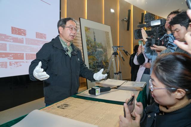 (251206) -- NANJING, Dec. 6, 2025 (Xinhua) -- Nanjing-born Chinese-American Lu Zhaoning introduces artifacts and historical materials at a press briefing held by the Memorial Hall of the Victims in Nanjing Massacre by Japanese Invaders in Nanjing, east China's Jiangsu Province, Dec. 5, 2025. The memorial hall on Friday said that it has collected 573 artifacts or sets of artifacts and historical materials this year, providing new evidence of war crimes related to the massacre that was perpetrated by invading Japanese troops during World War II.
   TO GO WITH "China memorial hall collects new evidence of Nanjing Massacre" (Xinhua/Li Bo)