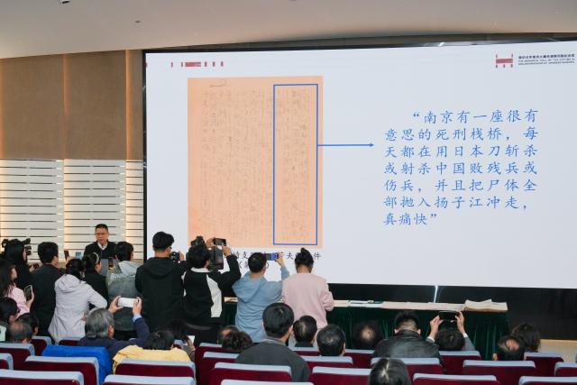 (251206) -- NANJING, Dec. 6, 2025 (Xinhua) -- A staff member introduces artifacts and historical materials collected in 2025 at a press briefing held by the Memorial Hall of the Victims in Nanjing Massacre by Japanese Invaders in Nanjing, east China's Jiangsu Province, Dec. 5, 2025. The memorial hall on Friday said that it has collected 573 artifacts or sets of artifacts and historical materials this year, providing new evidence of war crimes related to the massacre that was perpetrated by invading Japanese troops during World War II.
   TO GO WITH "China memorial hall collects new evidence of Nanjing Massacre" (Xinhua/Li Bo)