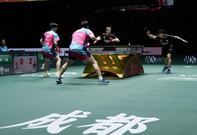 (251206) -- CHENGDU, Dec. 6, 2025 (Xinhua) -- Qiu Dang (1st R)/Benedikt Duda (2nd R) of Germany compete in the men's doubles match against Park Ganghyeon/An Jaehyun of South Korea during the stage 2 group match between Germany and South Korea at the ITTF Mixed Team World Cup 2025 in Chengdu, southwest China's Sichuan Province, Dec. 6, 2025. (Xinhua/Wang Ying)