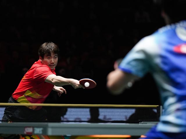 (251206) -- CHENGDU, Dec. 6, 2025 (Xinhua) -- Liang Jingkun of China hits a return during the men's singles match against Matsushima Sora of Japan during the stage 2 group match between China and Japan at the ITTF Mixed Team World Cup 2025 in Chengdu, southwest China's Sichuan Province, Dec. 6, 2025. (Xinhua/Wang Xi)