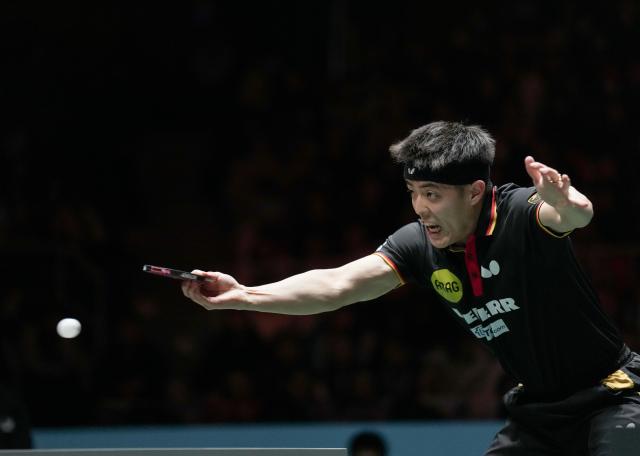 (251206) -- CHENGDU, Dec. 6, 2025 (Xinhua) -- Qiu Dang of Germany competes in the men's singles match against Jang Woojin of South Korea during the stage 2 group match between Germany and South Korea at the ITTF Mixed Team World Cup 2025 in Chengdu, southwest China's Sichuan Province, Dec. 6, 2025. (Xinhua/Wang Ying)