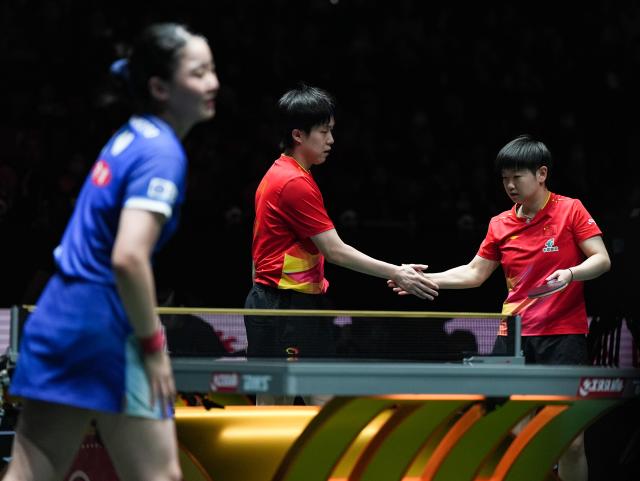 (251206) -- CHENGDU, Dec. 6, 2025 (Xinhua) -- Sun Yingsha/Wang Chuqin(C) of China react during the mixed doubles match against Harimoto Miwa/Togami Shunsuke of Japan during the stage 2 group match between China and Japan at the ITTF Mixed Team World Cup 2025 in Chengdu, southwest China's Sichuan Province, Dec. 6, 2025. (Xinhua/Wang Xi)