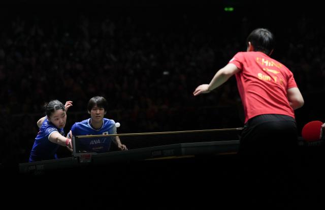 (251206) -- CHENGDU, Dec. 6, 2025 (Xinhua) -- Harimoto Miwa(L)/Togami Shunsuke of Japan compete during the mixed doubles match against Sun Yingsha/Wang Chuqin of China during the stage 2 group match between China and Japan at the ITTF Mixed Team World Cup 2025 in Chengdu, southwest China's Sichuan Province, Dec. 6, 2025. (Xinhua/Wang Ying)