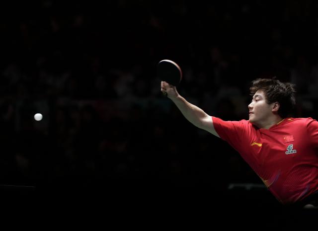 (251206) -- CHENGDU, Dec. 6, 2025 (Xinhua) -- Liang Jingkun of China hits a return during the men's singles match against Matsushima Sora of Japan during the stage 2 group match between China and Japan at the ITTF Mixed Team World Cup 2025 in Chengdu, southwest China's Sichuan Province, Dec. 6, 2025. (Xinhua/Wang Ying)