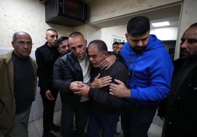 (251206) -- NABLUS, Dec. 6, 2025 (Xinhua) -- Relatives mourn over the Palestinian man Baha Abdel Rahman Rashed killed by the Israeli forces, at a hospital in the West Bank city of Nablus, on Dec. 5, 2025. The 38-year-old Baha Abdel Rahman Rashed, was shot dead by Israeli soldiers on Friday in the village of Odala, south of the city of Nablus in the northern West Bank, the Palestinian Ministry of Health said. (Photo by Ayman Nobani/Xinhua)