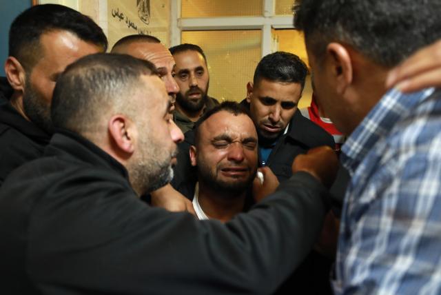 (251206) -- NABLUS, Dec. 6, 2025 (Xinhua) -- Relatives mourn over the Palestinian man Baha Abdel Rahman Rashed killed by the Israeli forces, at a hospital in the West Bank city of Nablus, on Dec. 5, 2025. The 38-year-old Baha Abdel Rahman Rashed, was shot dead by Israeli soldiers on Friday in the village of Odala, south of the city of Nablus in the northern West Bank, the Palestinian Ministry of Health said. (Photo by Ayman Nobani/Xinhua)