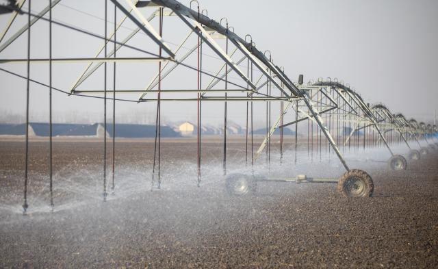 (251206) -- BEIJING, Dec. 6, 2025 (Xinhua) -- A drone photo taken on Dec. 6, 2025 shows sprinkler irrigation equipment working at a winter wheat field in Dongying City, east China's Shandong Province. As the solar term of Major Snow, also known as "Da Xue" in Chinese, is approaching, farmers are busy with agricultural production across the country. (Photo by Liu Yunjie/Xinhua)