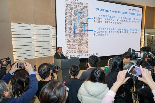 (251207) -- BEIJING, Dec. 7, 2025 (Xinhua) -- Nanjing-born Chinese-American Lu Zhaoning introduces artifacts and historical materials at a press briefing held by the Memorial Hall of the Victims in Nanjing Massacre by Japanese Invaders in Nanjing, east China's Jiangsu Province, Dec. 5, 2025. The memorial hall on Friday said that it has collected 573 artifacts or sets of artifacts and historical materials this year, providing new evidence of war crimes related to the massacre that was perpetrated by invading Japanese troops during World War II. (Xinhua/Li Bo)