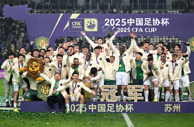 (251207) -- BEIJING, Dec. 7, 2025 (Xinhua) -- Team members of Beijing Guoan celebrate during the awarding ceremony after the final match against Henan FC at the 2025 CFA (Chinese Football Association) Cup in Suzhou, east China's Jiangsu Province, Dec. 6, 2025. (Xinhua/Li Jianan)