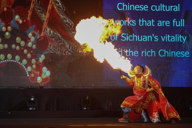 (251207) -- SIEM REAP, Dec. 7, 2025 (Xinhua) -- A Chinese artist blows the flame during a Cambodia-China music and cultural show in Siem Reap province, Cambodia on Dec. 6, 2025. The show was one of joint activities to promote the Cambodia-China Tourism Year 2025. (Photo by Sao Khuth/Xinhua)