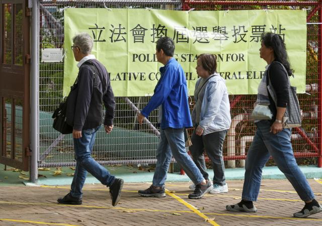(251207) -- HONG KONG, Dec. 7, 2025 (Xinhua) -- Citizens arrive at a polling station in Tai Po of Hong Kong, south China, Dec. 7, 2025. Voting for the election of the eighth-term Legislative Council (LegCo) of China's HKSAR kicked off Sunday morning. (Xinhua/Zhu Wei)