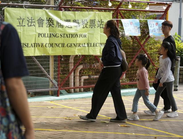(251207) -- HONG KONG, Dec. 7, 2025 (Xinhua) -- Citizens arrive at a polling station in Tai Po of Hong Kong, south China, Dec. 7, 2025. Voting for the election of the eighth-term Legislative Council (LegCo) of China's HKSAR kicked off Sunday morning. (Xinhua/Zhu Wei)