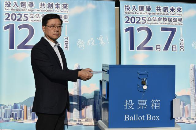 (251207) -- HONG KONG, Dec. 7, 2025 (Xinhua) -- Hong Kong Special Administrative Region (HKSAR) Chief Executive John Lee casts his ballot at a polling station in Hong Kong, south China, Dec. 7, 2025. Voting for the election of the eighth-term Legislative Council (LegCo) of China's HKSAR kicked off Sunday morning. (Xinhua/Lui Siu Wai)