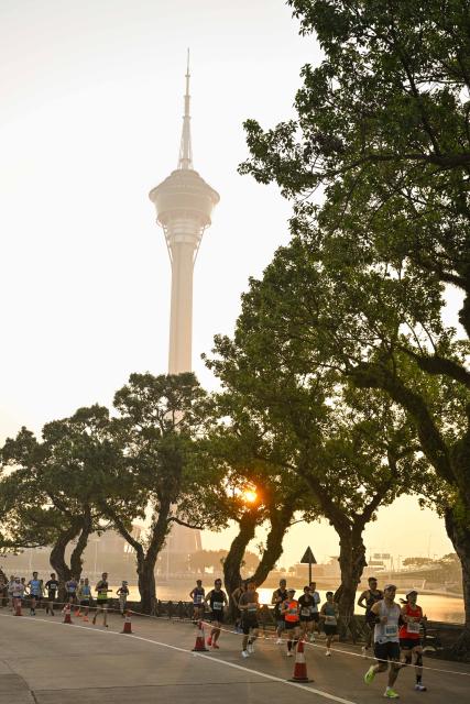 (251207) -- MACAO, Dec. 7, 2025 (Xinhua) -- Competitors run during the Macao International Marathon 2025 in Macao, South China, Dec. 7, 2025. (Xinhua)