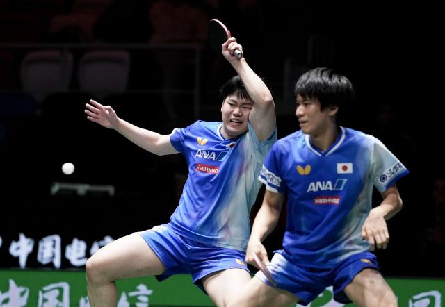 (251207) -- CHENGDU, Dec. 7, 2025 (Xinhua) -- Matsushima Sora(L)/Togami Shunsuke of Japan compete with Qiu Dang/Benedikt Duda of Germany during the men's doubles match of the semifinal between Japan and Germany at the ITTF Mixed Team World Cup 2025 in Chengdu, southwest China's Sichuan Province, Dec. 7, 2025. (Xinhua/Wang Ying)