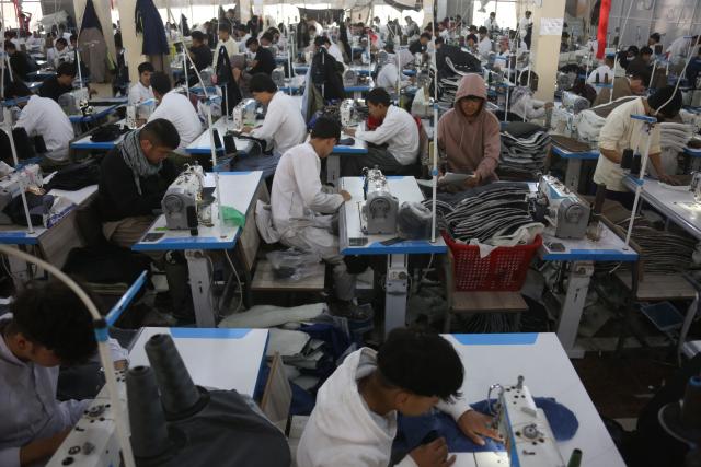 (251207) -- KABUL, Dec. 7, 2025 (Xinhua) -- People work at Max Garment Factory in Kabul, Afghanistan, on Dec. 4, 2025. TO GO WITH "Feature: Afghanistan's largest garment factory weaves new pathways with China-sourced materials" (Photo by Saifurahman Safi/Xinhua)