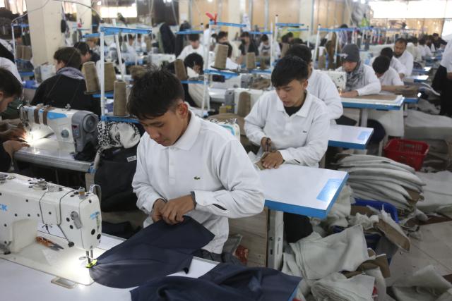(251207) -- KABUL, Dec. 7, 2025 (Xinhua) -- People work at Max Garment Factory in Kabul, Afghanistan, on Dec. 4, 2025. TO GO WITH "Feature: Afghanistan's largest garment factory weaves new pathways with China-sourced materials" (Photo by Saifurahman Safi/Xinhua)