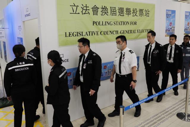 (251207) -- HONG KONG, Dec. 7, 2025 (Xinhua) -- Voters arrive at a polling station at Hong Kong International Airport in Hong Kong, south China, Dec. 7, 2025. Voting for the election of the eighth-term Legislative Council (LegCo) of China's Hong Kong Special Administrative Region (HKSAR) kicked off Sunday morning. (Xinhua/Wang Shen)