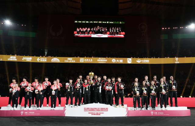 (251207) -- CHENGDU, Dec. 7, 2025 (Xinhua) -- Gold medalists team China (C), silver medalists team Japan (L) and bronze medalists team Germany are seen during the awarding ceremony at the ITTF Mixed Team World Cup 2025 in Chengdu, southwest China's Sichuan Province, Dec. 7, 2025. (Xinhua/Wang Ying)
