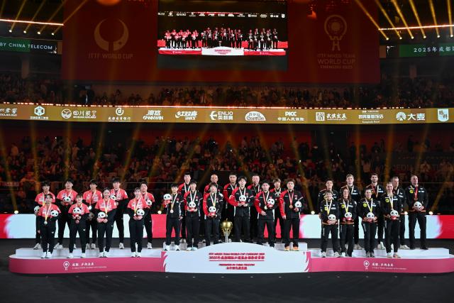(251207) -- CHENGDU, Dec. 7, 2025 (Xinhua) -- Gold medalists team China (C), silver medalists team Japan (L) and bronze medalists team Germany are seen during the awarding ceremony at the ITTF Mixed Team World Cup 2025 in Chengdu, southwest China's Sichuan Province, Dec. 7, 2025. (Xinhua/Xu Bingjie)