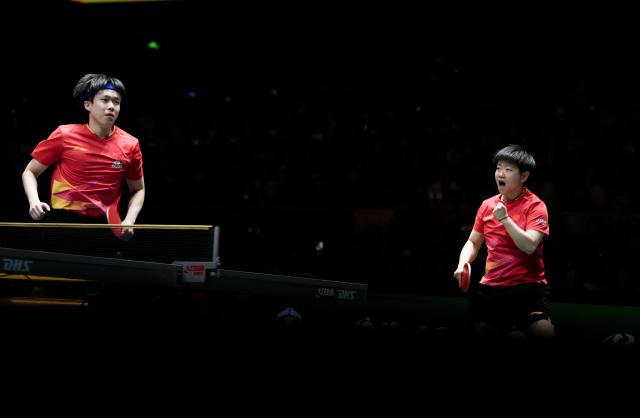 (251207) -- CHENGDU, Dec. 7, 2025 (Xinhua) -- Wang Chuqin (L)/Sun Yingsha of China react in the mixed doubles match against Matsushima Sora/Odo Satsuki of Japan during the final match between China and Japan at the ITTF Mixed Team World Cup 2025 in Chengdu, southwest China's Sichuan Province, Dec. 7, 2025. (Xinhua/Wang Ying)