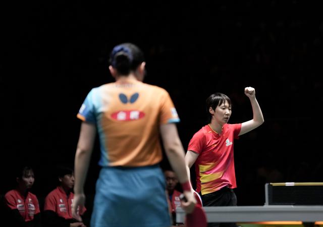 (251207) -- CHENGDU, Dec. 7, 2025 (Xinhua) -- Wang Manyu (R) of China reacts in the women's singles match against Harimoto Miwa of Japan during the final match between China and Japan at the ITTF Mixed Team World Cup 2025 in Chengdu, southwest China's Sichuan Province, Dec. 7, 2025. (Xinhua/Wang Ying)
