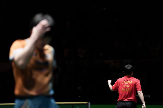 (251207) -- CHENGDU, Dec. 7, 2025 (Xinhua) -- Lin Shidong of China reacts in the men's singles match against Harimoto Tomokazu of Japan during the final match between China and Japan at the ITTF Mixed Team World Cup 2025 in Chengdu, southwest China's Sichuan Province, Dec. 7, 2025. (Xinhua/Wang Ying)