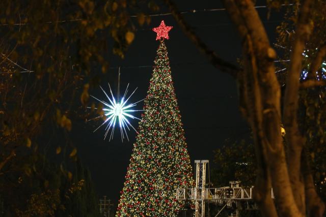 (251208) -- BETHLEHEM, Dec. 8, 2025 (Xinhua) -- A Christmas tree is lit at the Manger Square in Bethlehem, southern West Bank on Dec. 6, 2025. Hundreds of residents and visitors attended a Christmas tree-lighting event here Saturday to mark the beginning of this year's Christmas celebrations. (Photo by Mamoun Wazwaz/Xinhua)