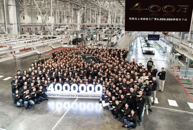(251208) -- SHANGHAI, Dec. 8, 2025 (Xinhua) -- Staff members pose for a group photo to mark the 4 millionth vehicle produced here at Tesla's Gigafactory in Shanghai, east China, Dec. 8, 2025. TO GO WITH "Tesla Shanghai factory hits 4-mln car output mark" (Tesla's Gigafactory in Shanghai/Handout via Xinhua)