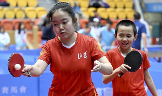 (251208) -- HONG KONG, Dec. 8, 2025 (Xinhua) -- Ma Yifan/Zhao Zhuya (L) of Shanxi compete during the mixed doubles age 12-15 group A match of special olympics table tennis at China's 12th National Games for Persons with Disabilities and the 9th National Special Olympic Games in Hong Kong, south China, Dec. 8, 2025. (Xinhua/Zhu Zheng)