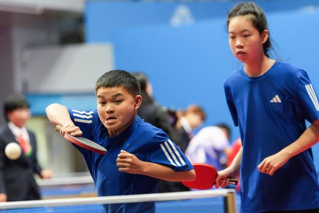 (251208) -- HONG KONG, Dec. 8, 2025 (Xinhua) -- Jiang Longjun (L)/Tong Xinyue of Zhejiang compete during the mixed doubles age 12-15 group A match of special olympics table tennis at China's 12th National Games for Persons with Disabilities and the 9th National Special Olympic Games in Hong Kong, south China, Dec. 8, 2025. (Xinhua/Zhu Zheng)