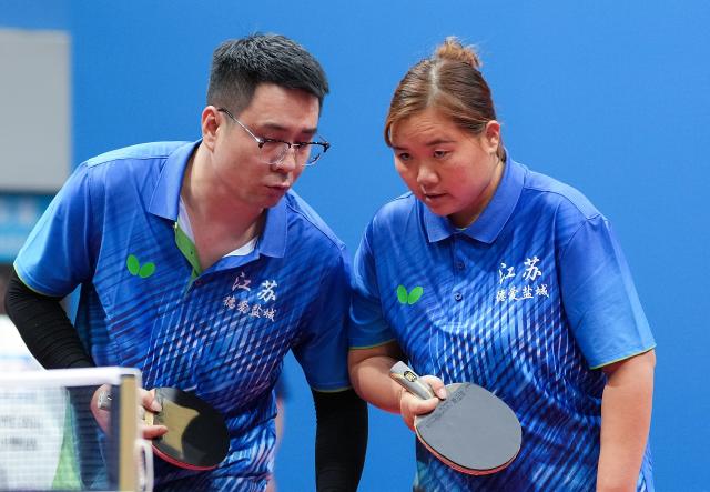 (251208) -- HONG KONG, Dec. 8, 2025 (Xinhua) -- Zhang Liangzhong (L)/Xia Jinglan of Jiangsu react during the mixed doubles age 30+ group A match of special olympics table tennis at China's 12th National Games for Persons with Disabilities and the 9th National Special Olympic Games in Hong Kong, south China, Dec. 8, 2025. (Xinhua/Zhu Zheng)