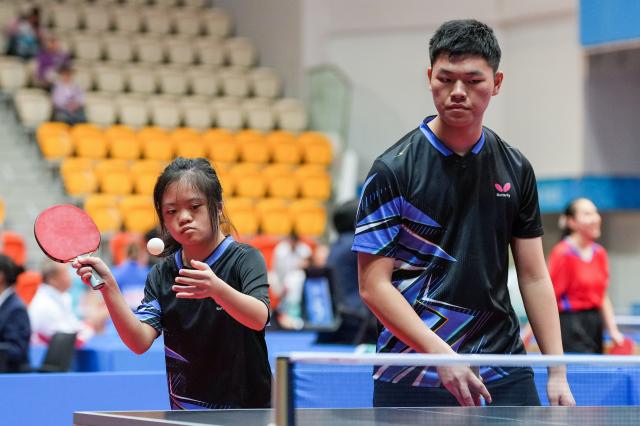 (251208) -- HONG KONG, Dec. 8, 2025 (Xinhua) -- Zhang Fujie/Liu Jiazhen (L) of Guangdong compete during the mixed doubles age 16-21 group C match of special olympics table tennis at China's 12th National Games for Persons with Disabilities and the 9th National Special Olympic Games in Hong Kong, south China, Dec. 8, 2025. (Xinhua/Zhu Zheng)