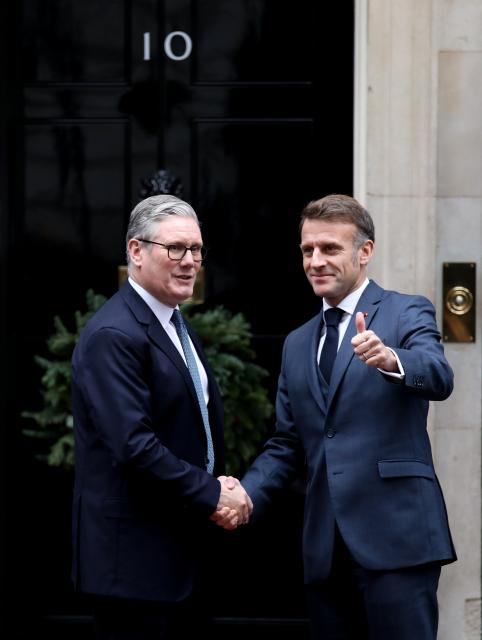 (251208) -- LONDON, Dec. 8, 2025 (Xinhua) -- British Prime Minister Keir Starmer (L) shakes hands with French President Emmanuel Macron prior to a meeting between the leaders of Britain, France, Germany and Ukraine at 10 Downing Street in London, Britain, Dec. 8, 2025. (Xinhua/Li Ying)