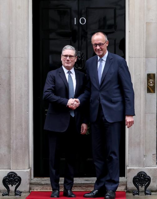 (251208) -- LONDON, Dec. 8, 2025 (Xinhua) -- British Prime Minister Keir Starmer (L) shakes hands with German Chancellor Friedrich Merz prior to a meeting between the leaders of Britain, France, Germany and Ukraine at 10 Downing Street in London, Britain, Dec. 8, 2025. (Xinhua/Li Ying)