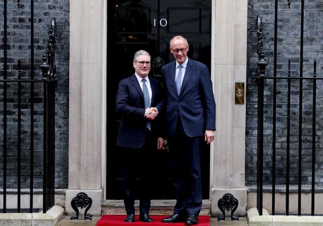 (251208) -- LONDON, Dec. 8, 2025 (Xinhua) -- British Prime Minister Keir Starmer (L) shakes hands with German Chancellor Friedrich Merz prior to a meeting between the leaders of Britain, France, Germany and Ukraine at 10 Downing Street in London, Britain, Dec. 8, 2025. (Xinhua/Li Ying)